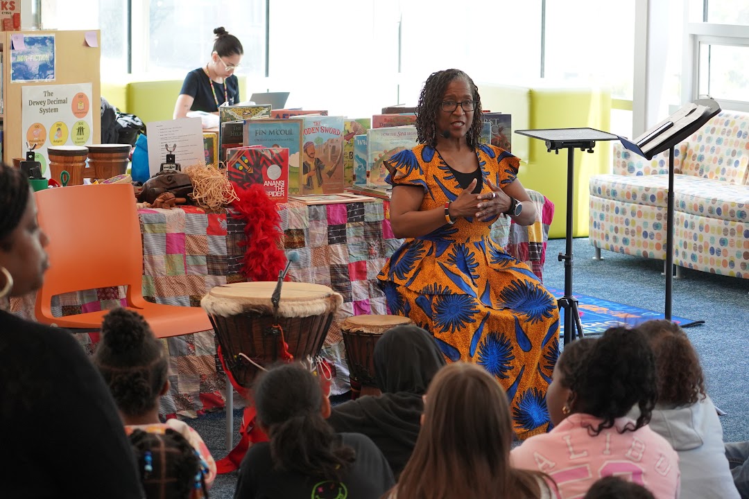 Children listening to Leslie tell a story in a library